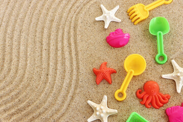 Top view image of beach toys on sand