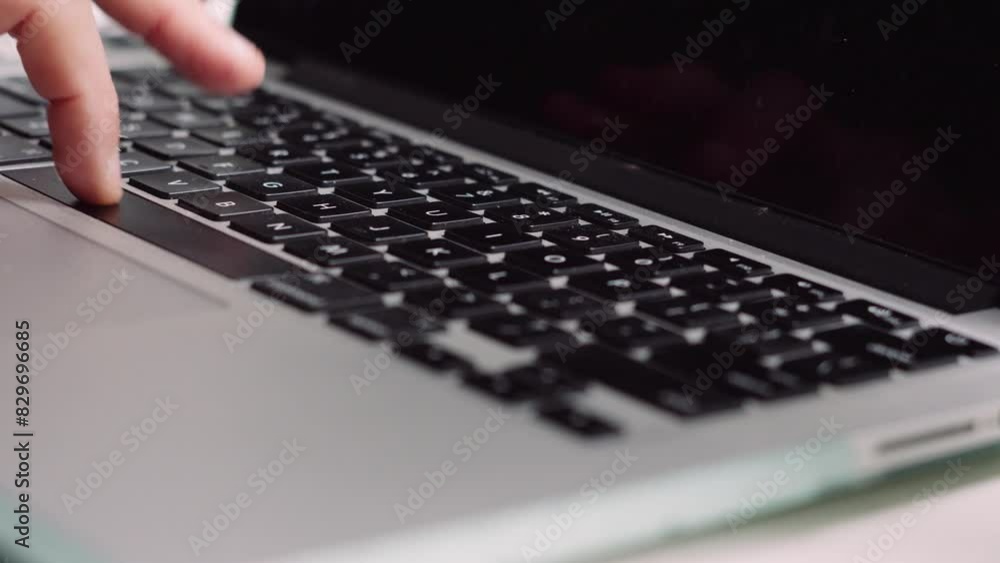 Poster hand typing on laptop keyboard whilst working from home and sending emails