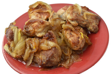 Fried meat cut into pieces, ready to eat, lies on a plate. Close-up.