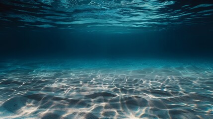 Underwater Scene with Sunlight Filtering Through Crystal Clear Water onto Sandy Ocean Floor