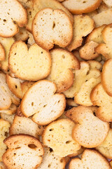 Pile of round bread croutons, slices of whole wheat toast, top view