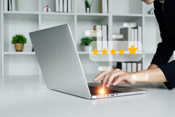 A woman is holding a tablet and pointing to a 5 star rating