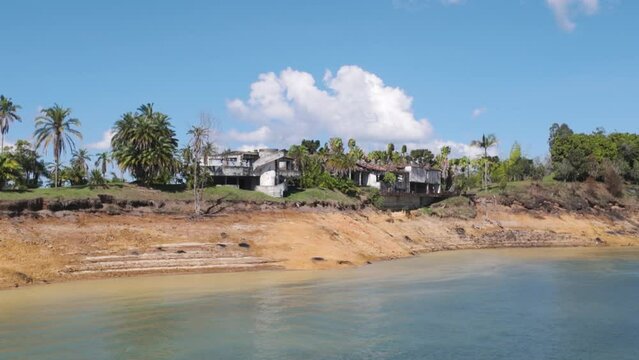 Ruined Escobar mansion "La Manuela" in Colombia surrounded by lush greenery and calm water