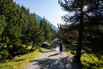 Young hiker woman in Vall de Boi, Aiguestortes and Sant Maurici National Park, Spain