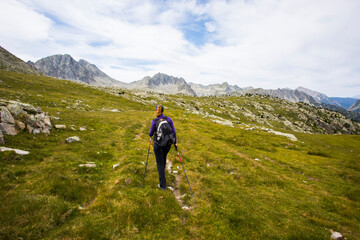 Young hiker woman in Vall de Boi, Aiguestortes and Sant Maurici National Park, Spain