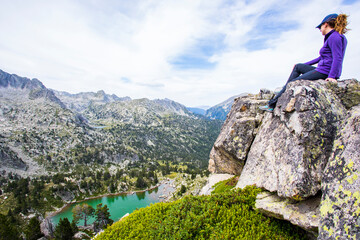 Young hiker woman in Vall de Boi, Aiguestortes and Sant Maurici National Park, Spain
