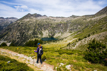 Fototapeta premium Young hiker woman in Vall de Boi, Aiguestortes and Sant Maurici National Park, Spain