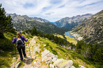Fototapeta premium Young hiker woman in Vall de Boi, Aiguestortes and Sant Maurici National Park, Spain