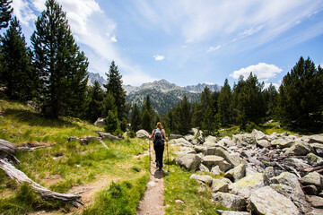 Fototapeta premium Young hiker woman in Vall de Boi, Aiguestortes and Sant Maurici National Park, Spain