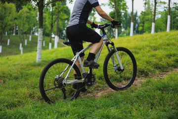 Fototapeta premium Woman mountain biking on mountain trail