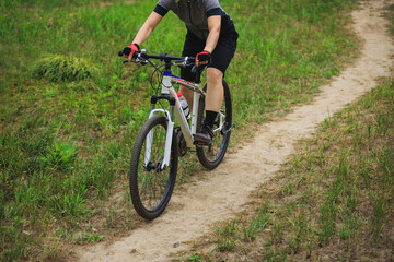 Fototapeta premium Woman mountain biking on mountain trail