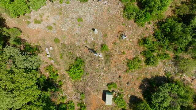 Slow aerial spinning shot of a gap in the forest in Pu&eacute;chabon with solar panels