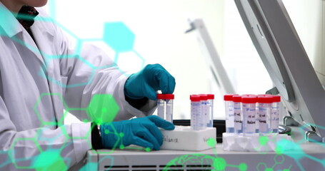 Image of scientific data processing over caucasian male scientist with test tubes in laboratory