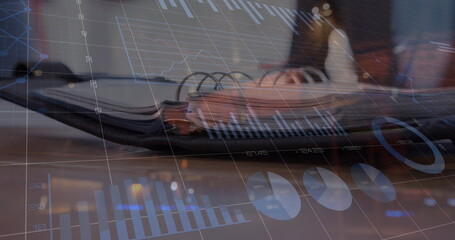 Image of statistical data processing against close up view of a open diary on office table