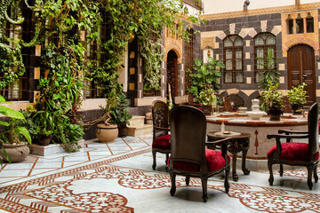 Interior of luxury hotel in oriental style with living plants and fountain in the lobby