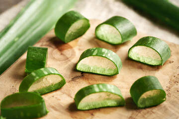Slices of fresh aloe vera leaves on a wooden cutting board