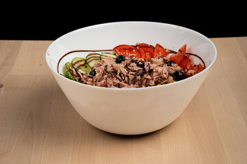 Bowl of fresh mixed salad with fish and assorted ingredients
