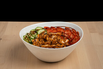 White bowl with meat and vegetables