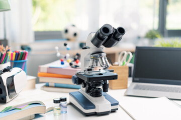 Science student desk with microscope