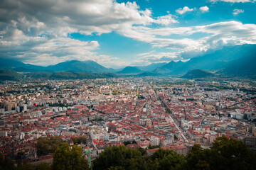 Fototapeta premium Mountain Embrace: Grenoble's Urban Tapestry Tucked in the Alps