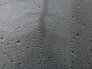 The texture of condensate water on a polyethylene film. Water drops on the glass. Natural...