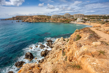 Panoramic view over the Golden Bay and beach (Ghajn Tuffieha) with turquoise, azure sea, Malta travel destination.