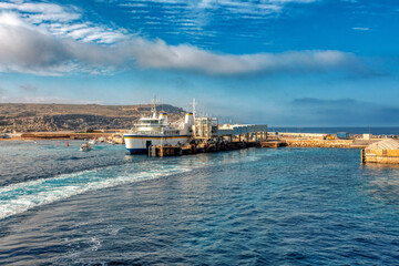 Malta to Gozo, Passengers board modern ferry at Cirkewwa Passenger terminal for scenic cruise to idyllic Gozo Island. Malta travel destination.