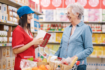 Supermarket clerk helping a senior customer