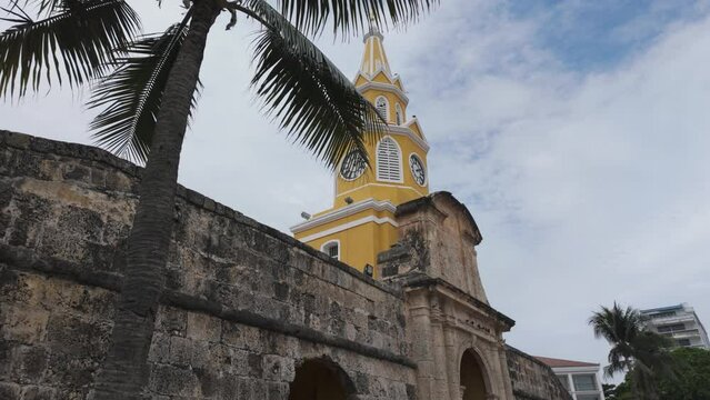 Historic Torre del Reloj monument in Cartagena, Colombia, with colonial architecture and palm trees