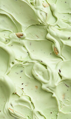 Fototapeta premium pistachio ice cream surface close-up shot, a closeup of the pistachio ice cream texture, featuring its creamy base with a light green tint and pieces of pistachio nuts