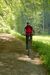 Person cycling in the Toss Valley region near Zurich, Switzerland