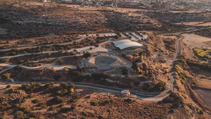 Fototapeta premium City on beach next to ocean with numerous boats in Kourion Amphitheater, Cyprus