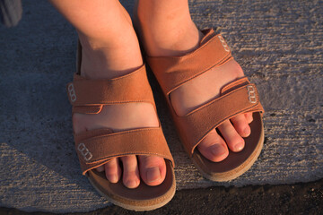 Person in sandals standing on the ground