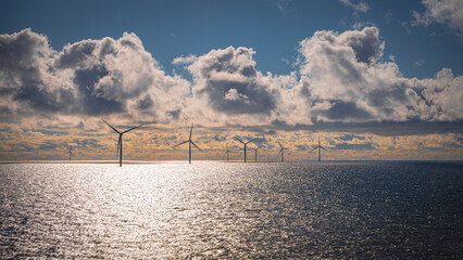 Windmills on the horizon in water