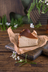 San Sebastian cheesecake on craft paper on wooden background