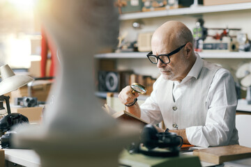 Business owner checking vintage items in his shop