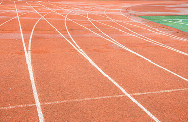 Fototapeta premium Bright red runway of a university in Wuhan. The white curve intersects with the straight line.