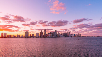 Fototapeta premium Scenic view of pink sunset in a modern city with skyscrapers