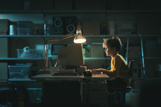 Smart kid using an old computer at night