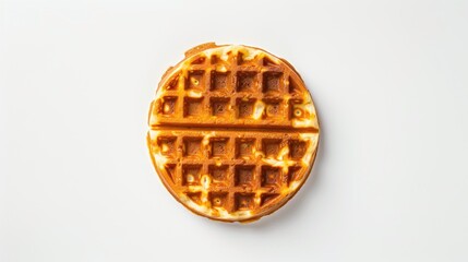 A waffle is sitting on a white background. The waffle is golden brown and has a crispy texture