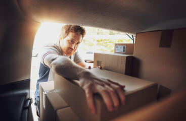 Delivery man loading packages into a van