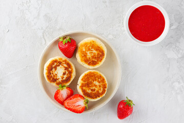 Vegan cheesecakes with berries, sweet sauce, cashew and tofu. Healthy breakfast. Syrniki, cheese pancakes.