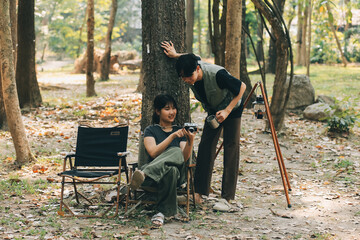 Asian couple sweet in tent inside on they camping trip, traveller relax and sleep togather in out...