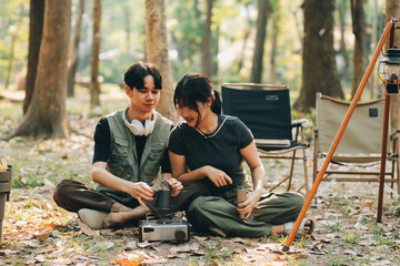 Asian couple sweet in tent inside on they camping trip, traveller relax and sleep togather in out...