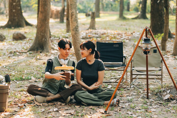 Asian couple sweet in tent inside on they camping trip, traveller relax and sleep togather in out...