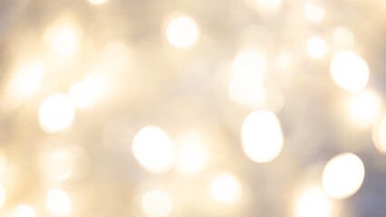 Fototapeta premium Golden bokeh background with soft, shimmering lights creating a warm ambiance.