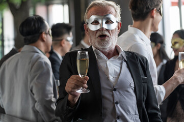 Champagne glasses holding on hand's Elder man in funny and happy Christmas and new year party atmosphere. Holiday celebrate and nightlife lifestyle concept