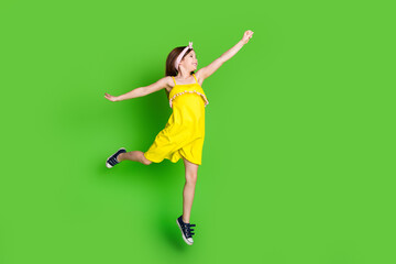 Full length photo of girlish pretty little lady dressed yellow outfit jumping high empty space...