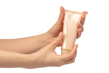 Beige cream tube in woman hands isolated on a white background.