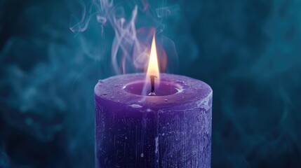 Fototapeta premium Close up image of a violet candle burning on a dark background with funeral connotations